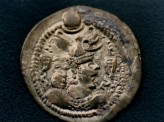 Fig. 3. Sasanian silver coin with royal portrait showing a horned helmet. Recovered in Dulan, Qingha. &copy; Qinghai Archaeological Institute