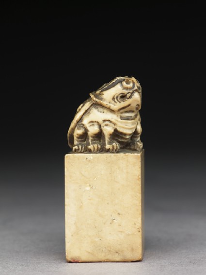 Soapstone seal surmounted by six-legged toadside