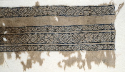 Textile fragment with bands of inverted hooks, flowers, and trianglesfront