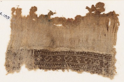 Textile fragment with S-shapes and rosettesfront