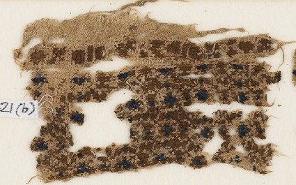 Textile fragment with diamond-shapes in squaresfront