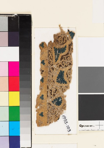 Textile fragment with swirling vegetal pattern and trefoil shapesfront