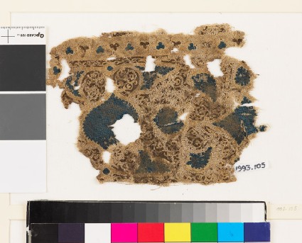 Textile fragment with swirling vegetal pattern and trefoil shapesfront