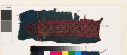 Textile fragment from a garment with linked diamond-shapes and double heartsfront