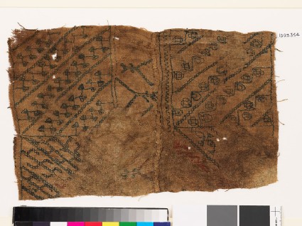 Sampler with diagonal lines, hooks, and stylized flower-headsfront