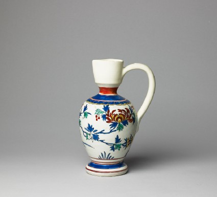 Jug with flowering plantsside