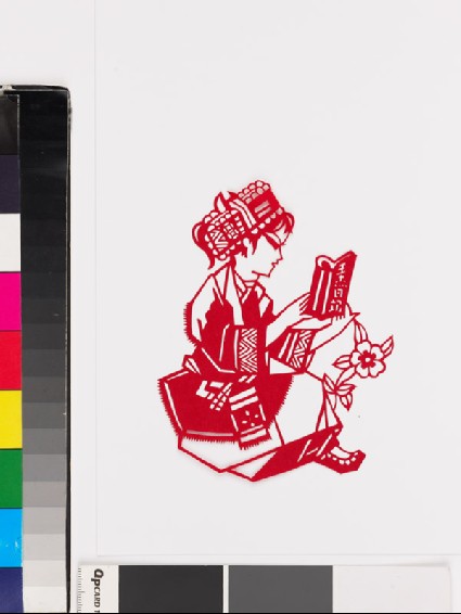 Girl in national minority costume reading a bookfront