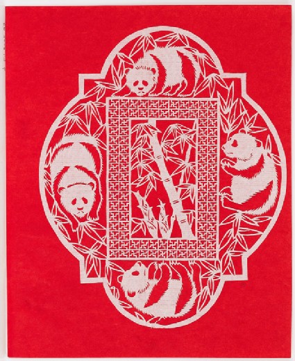 Four pandas among bamboofront