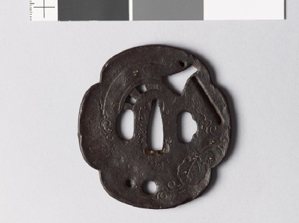 Mokkō-shaped tsuba with foliage, axe, and chariot wheelfront