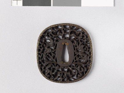 Tsuba with two dragons amid karakusa, or scrolling plant patternfront