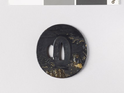 Tsuba depicting a fisherman on a beachfront