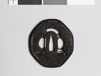 Octagonal tsuba depicting Yamabushi, or itinerant friars, carrying a portable book boxfront