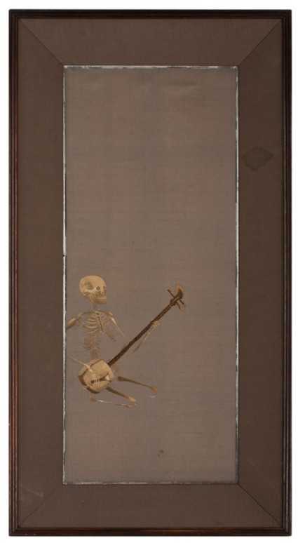 Skeleton kneeling playing a shamisen, or plucked instrumentfront, Cat. No. 38