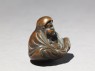 Netsuke in the form of Daruma meditating (side)