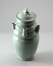 Greenware or qingbai ware funerary vase with lid surmounted by a dog (oblique)